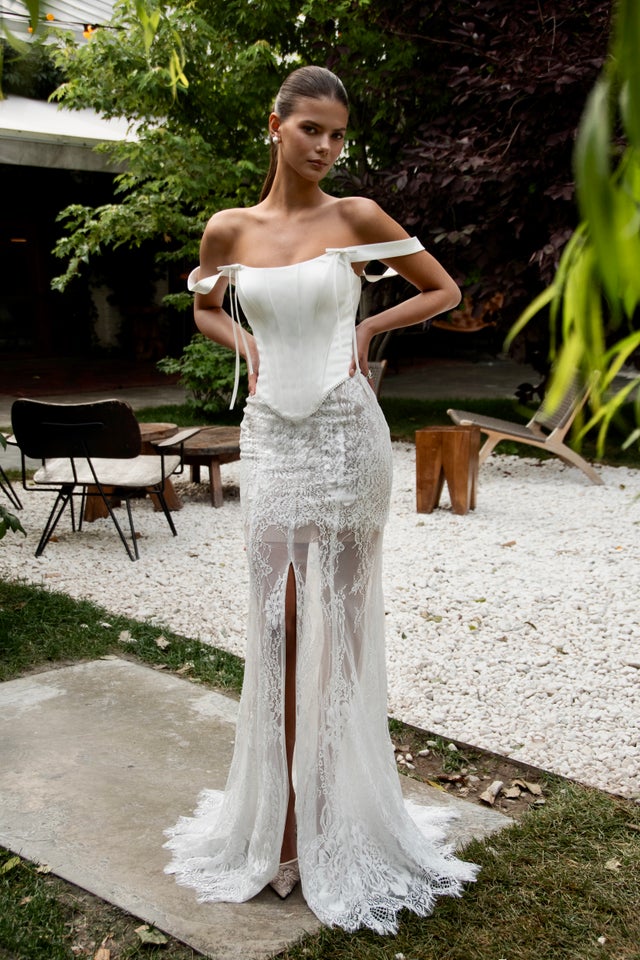 modern fancy dress A nude-toned modern bridal dress designed for my client, featuring custom frills for a subtle vintage influence. The combination of Chantilly lace and crystal embellishments creates depth, texture, and a refined contemporary